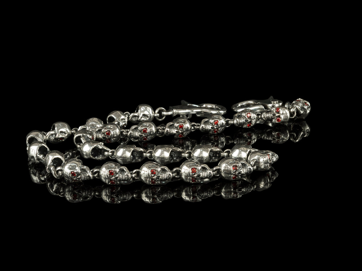 Mitchell silver skull chain laid out on black, full length view