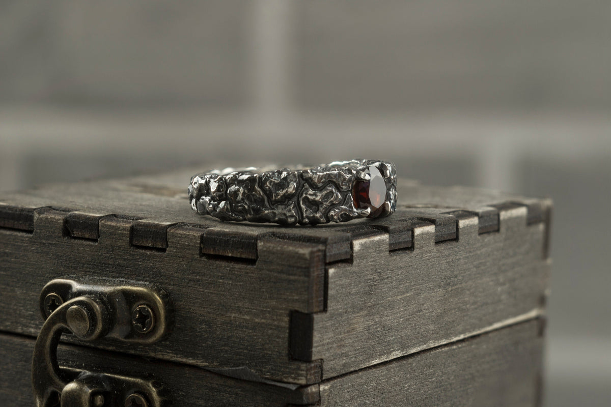 Mons Igneus men's garnet ring on a wooden box, other side