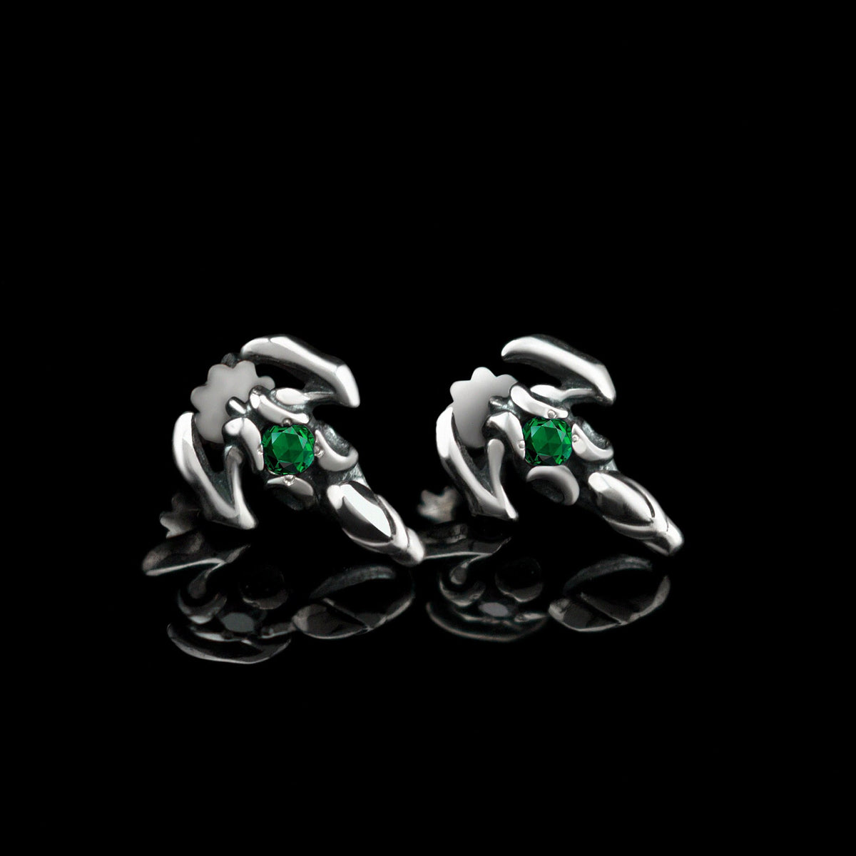 Silver scorpion stud earrings with green cubic zirconia