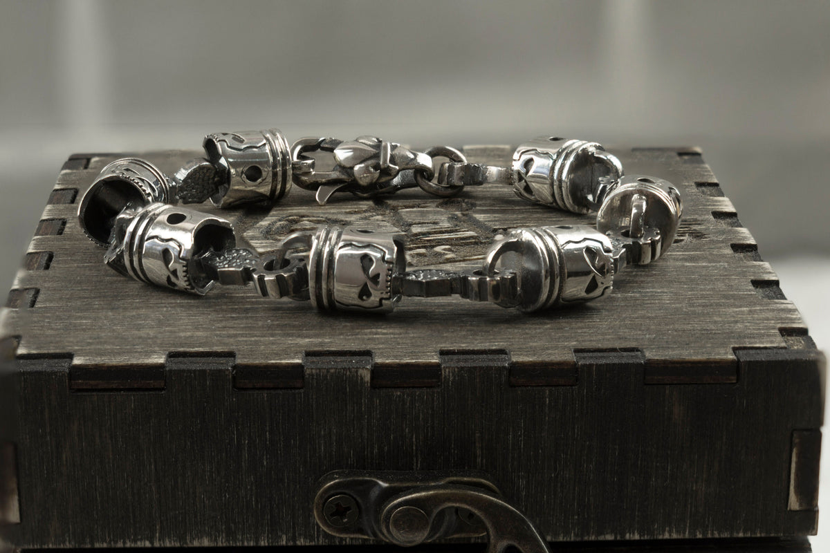 Skull piston bracelet across the lid of a wooden gift box