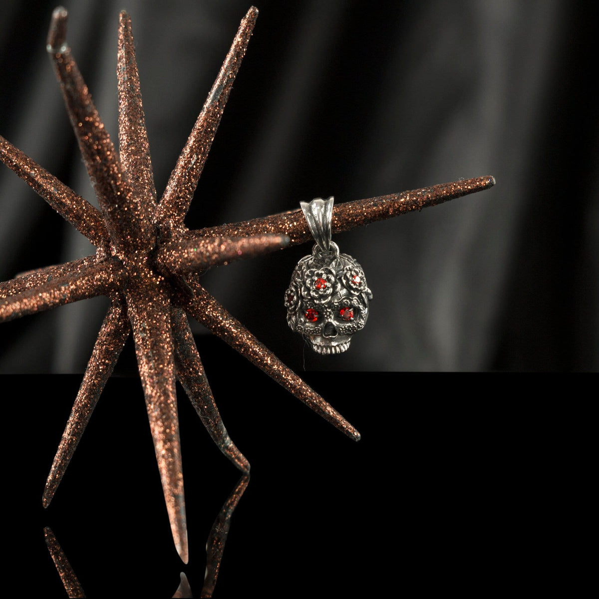 Tiny Frida sterling silver floral skull pendant with red stone eyes, with starfish