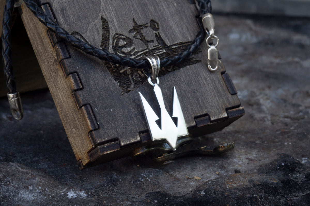 Close-up of the sterling silver Tryzub on a black cord