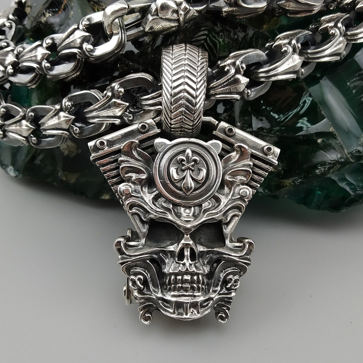 Vigor V-twin pendant hanging on a chain, full front view