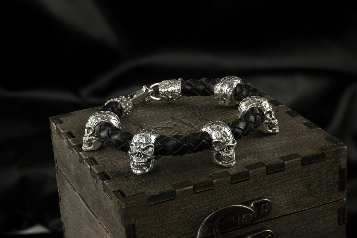 Wild skull leather bracelet lying on a wooden gift box