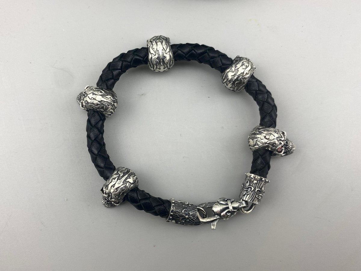 Wild leather bracelet from above with silver skulls and beads