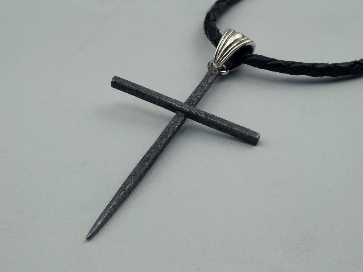 Black Spike sterling silver cross pendant, angled view of the textured matte finish