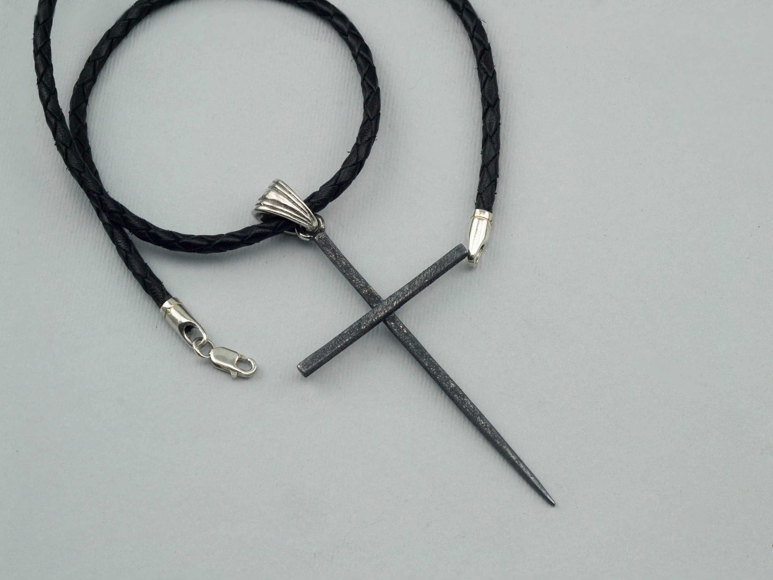 Black Spike oxidized sterling silver cross pendant with ribbed bail on a black braided leather cord