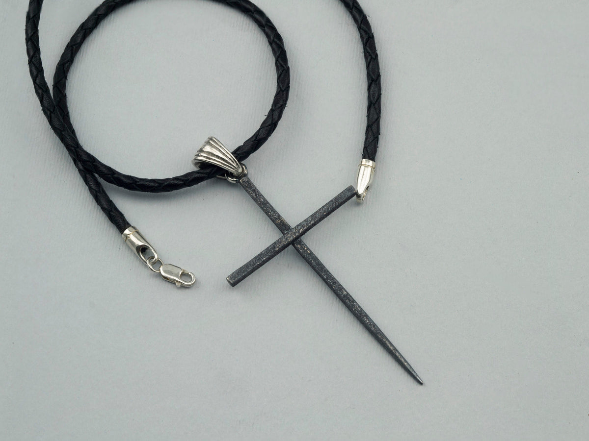Black Spike oxidized sterling silver cross pendant with ribbed bail on a black braided leather cord