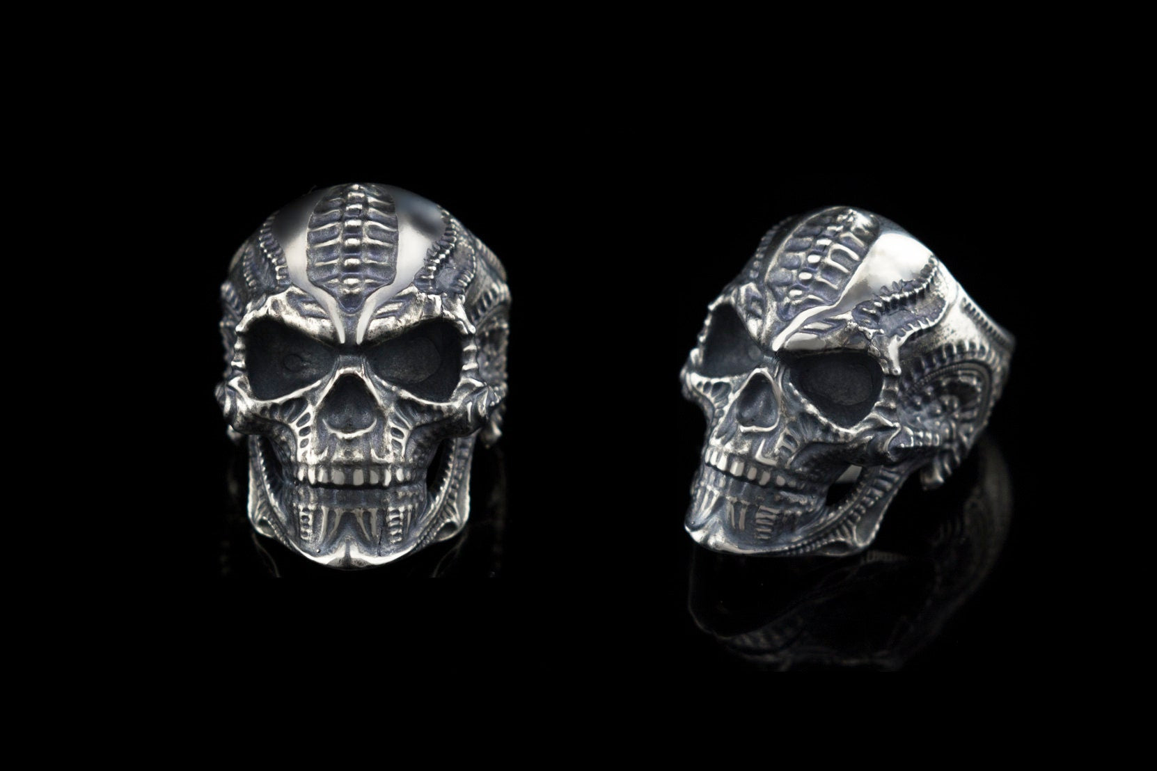 Two views of the Blade biomechanical skull ring on black