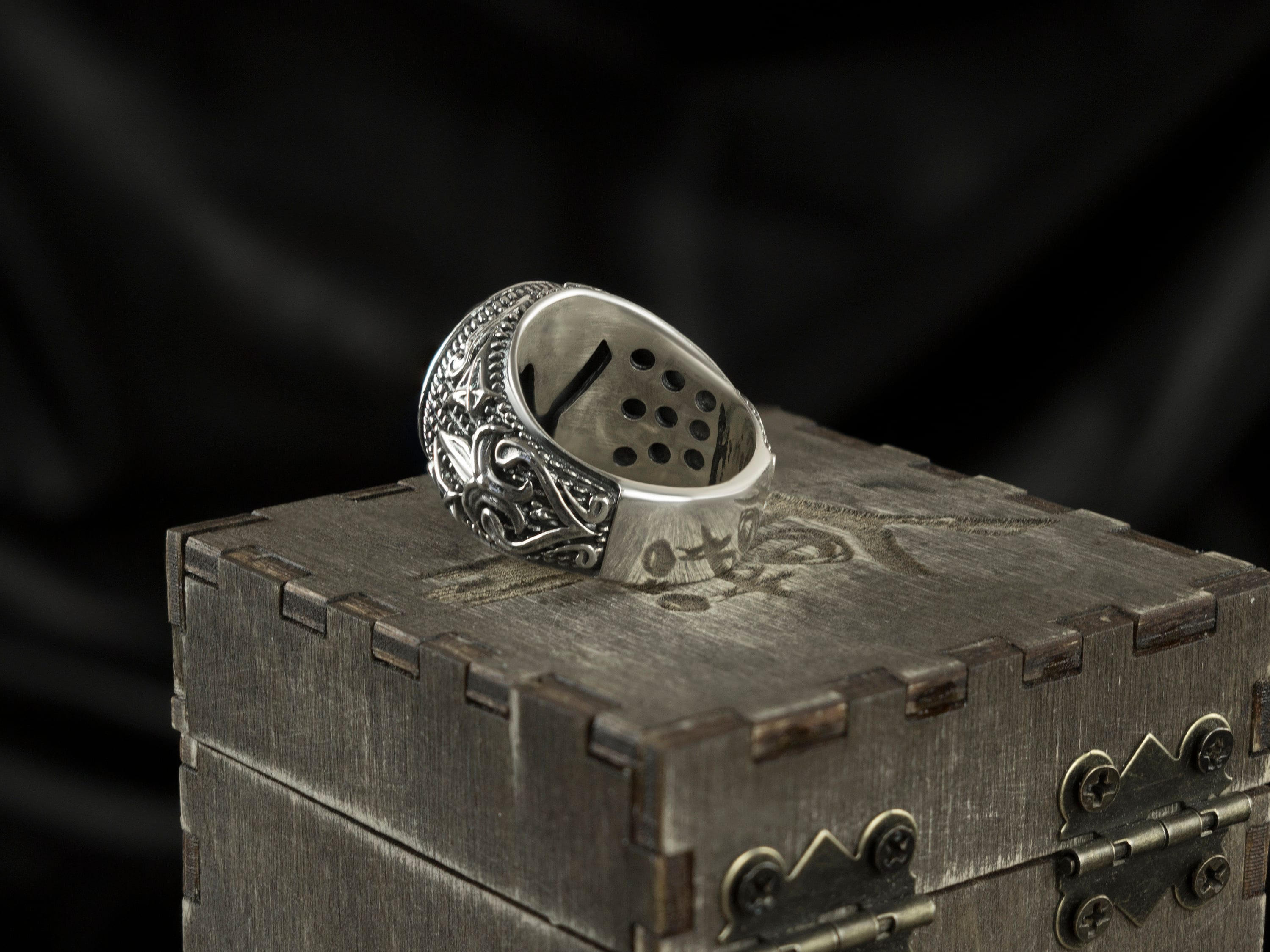 Blade Boss skull ring lying on its side, inside of the band