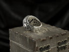 Blade Boss skull ring lying on its side, inside of the band