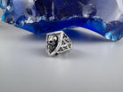 Shield skull ring three-quarter view with patterned shoulder