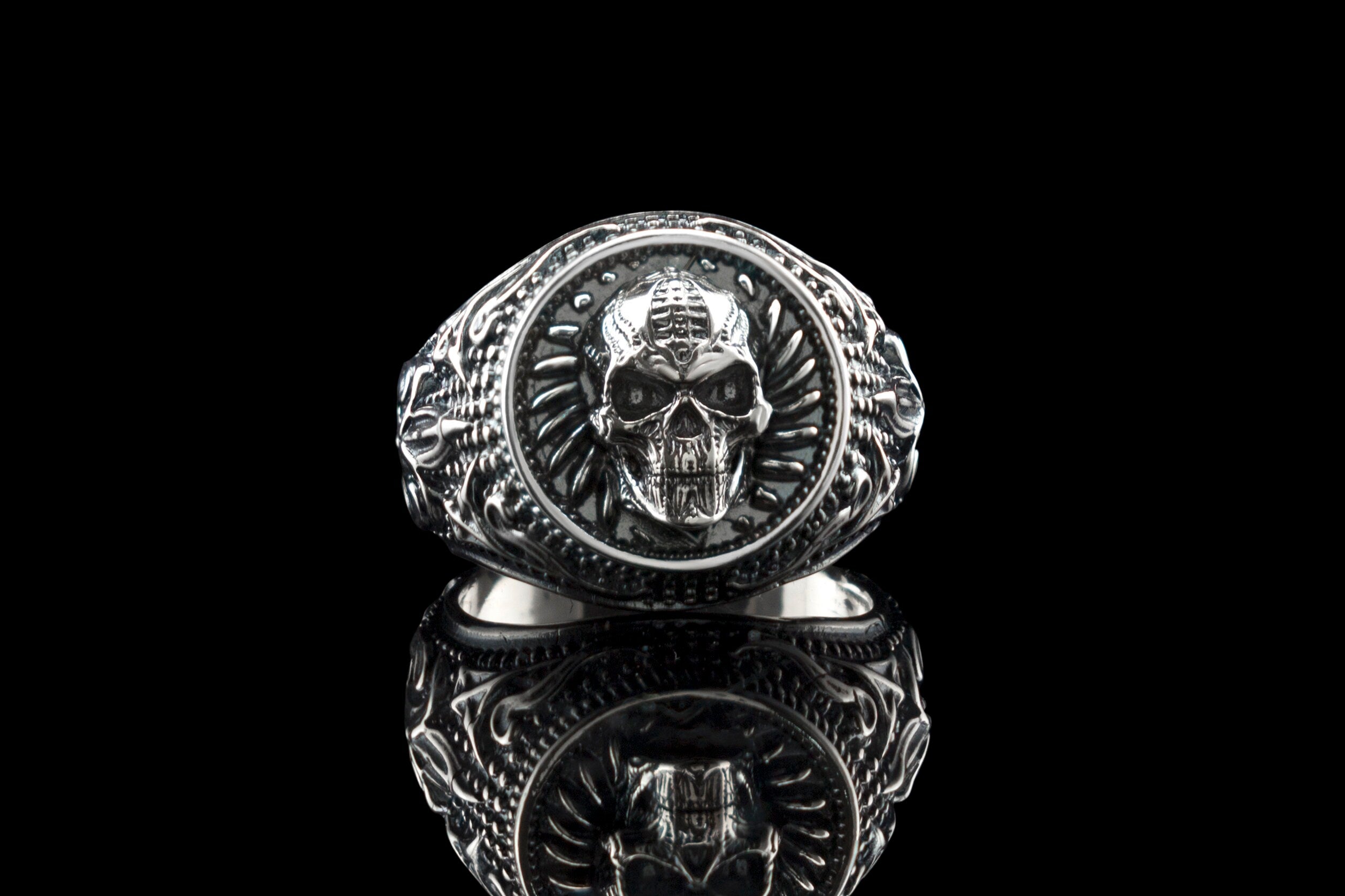 Blade Boss skull ring front view on black with reflection