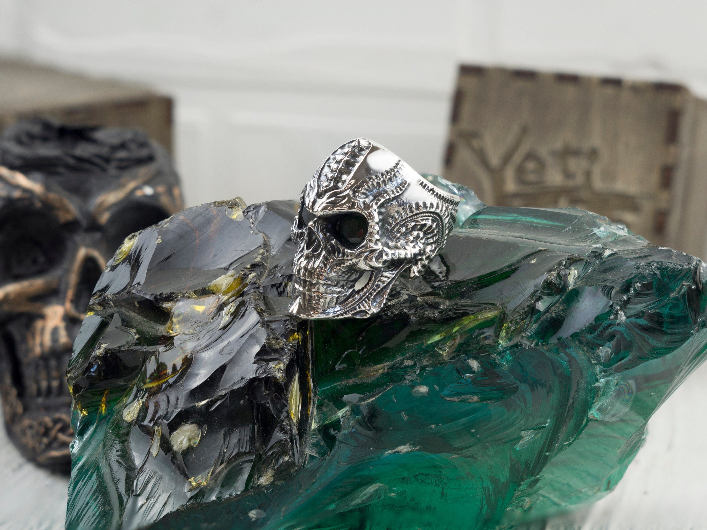 Blade skull ring with dark eyes, three-quarter view