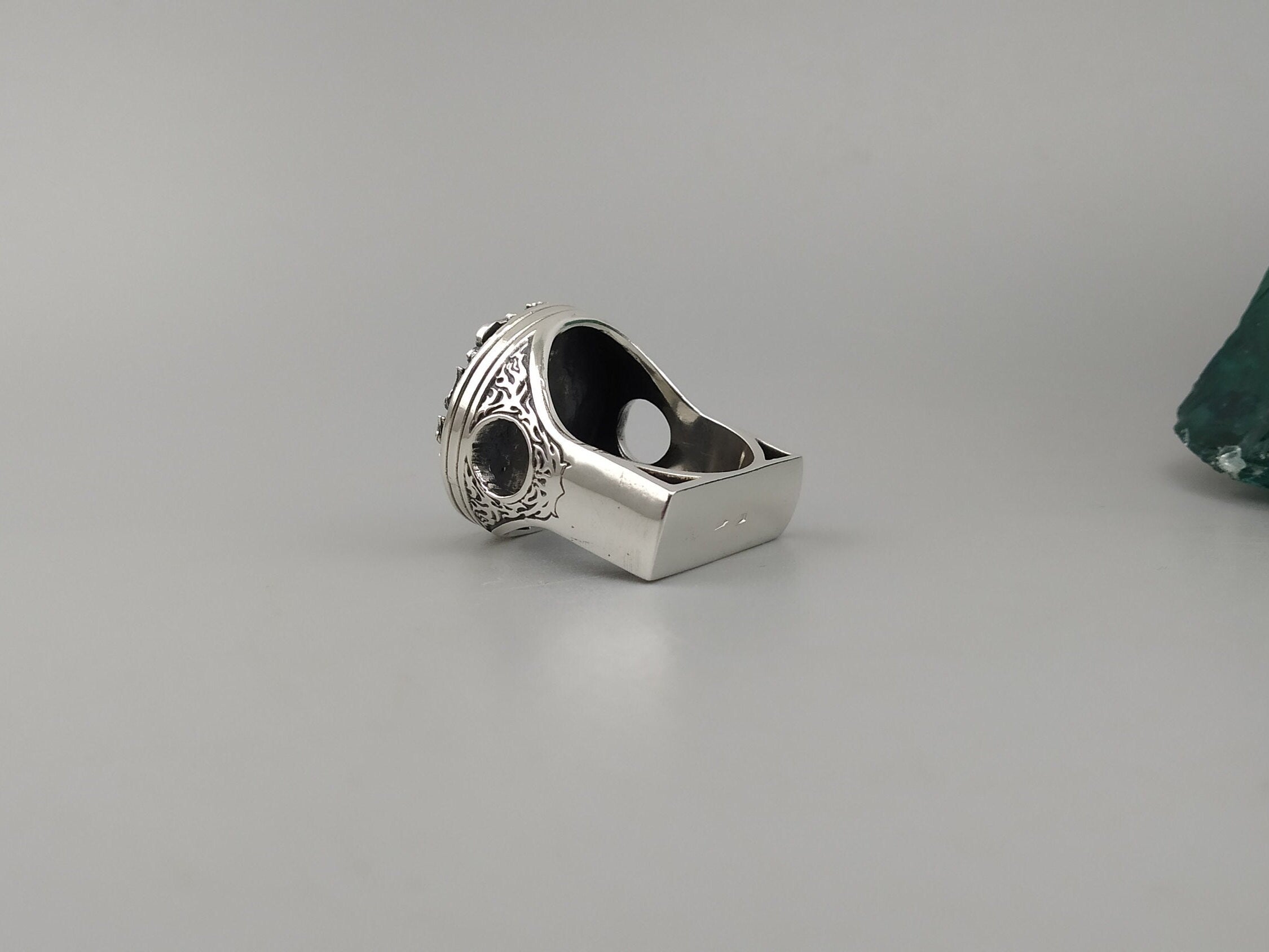 Side profile of the heavy piston skull ring showing the mechanical cutouts
