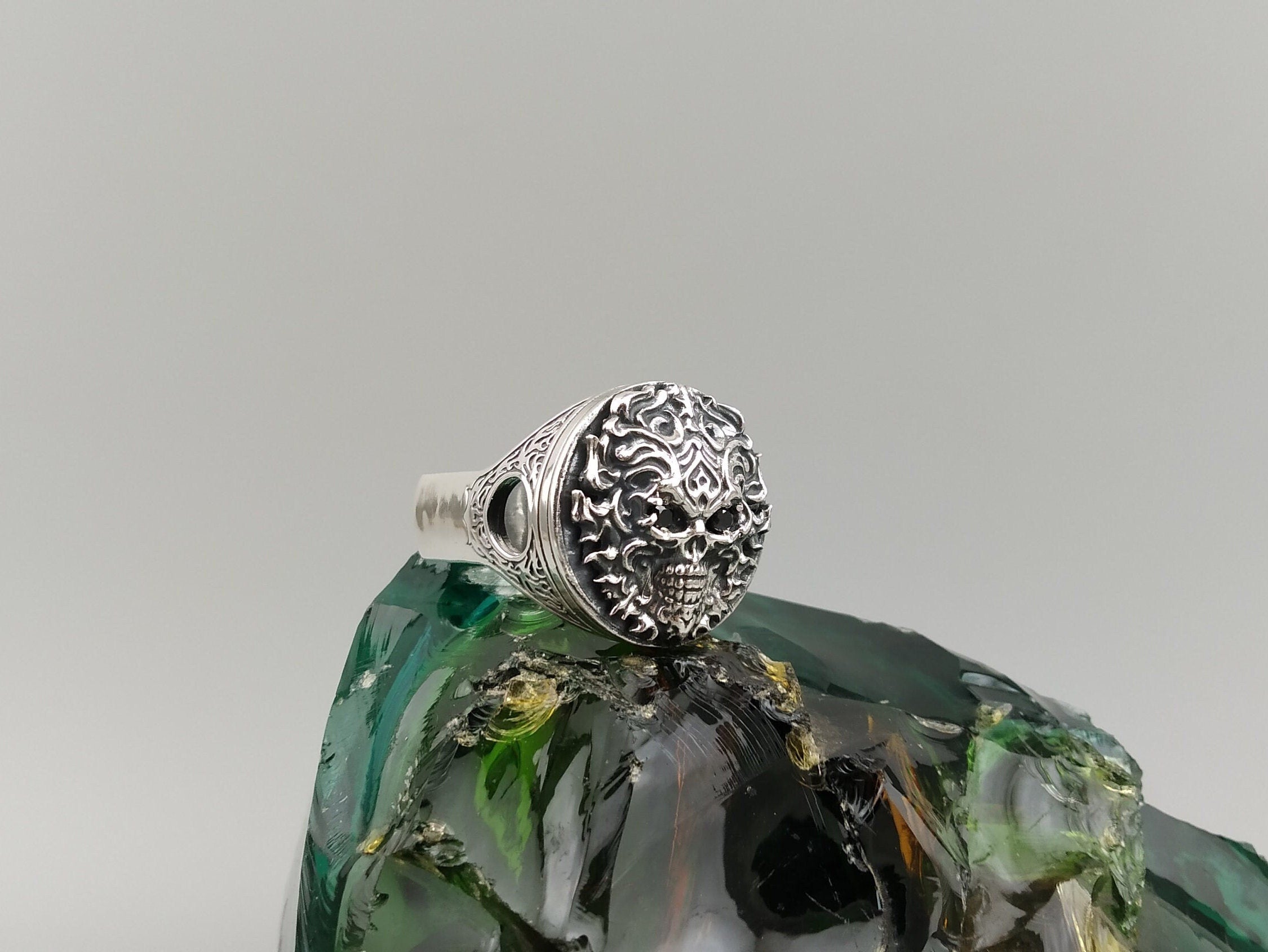 Blazing skull ring front view showing flame relief around the skull