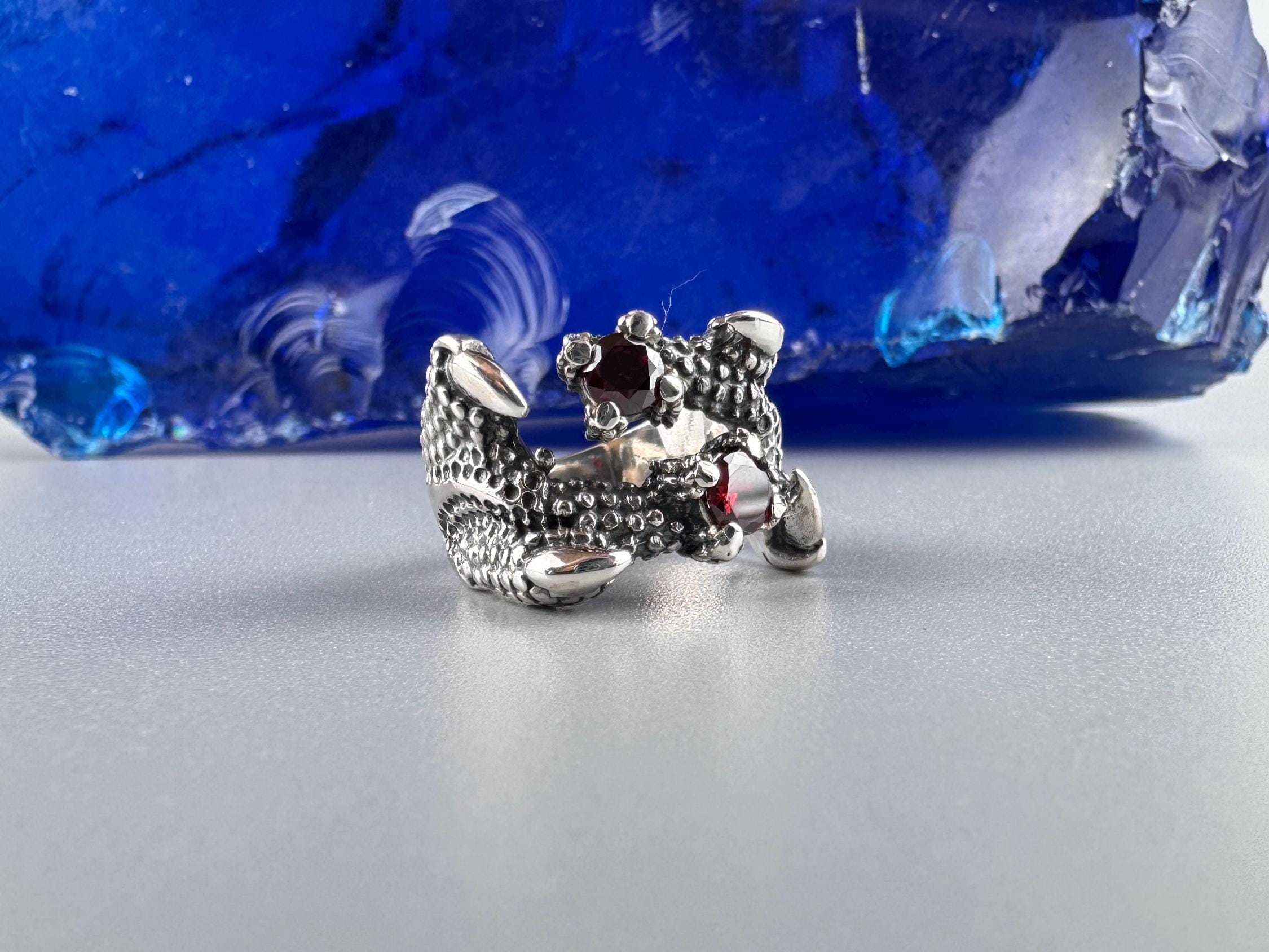 Crimson Claw dragon sterling silver ring with two red garnets, front view