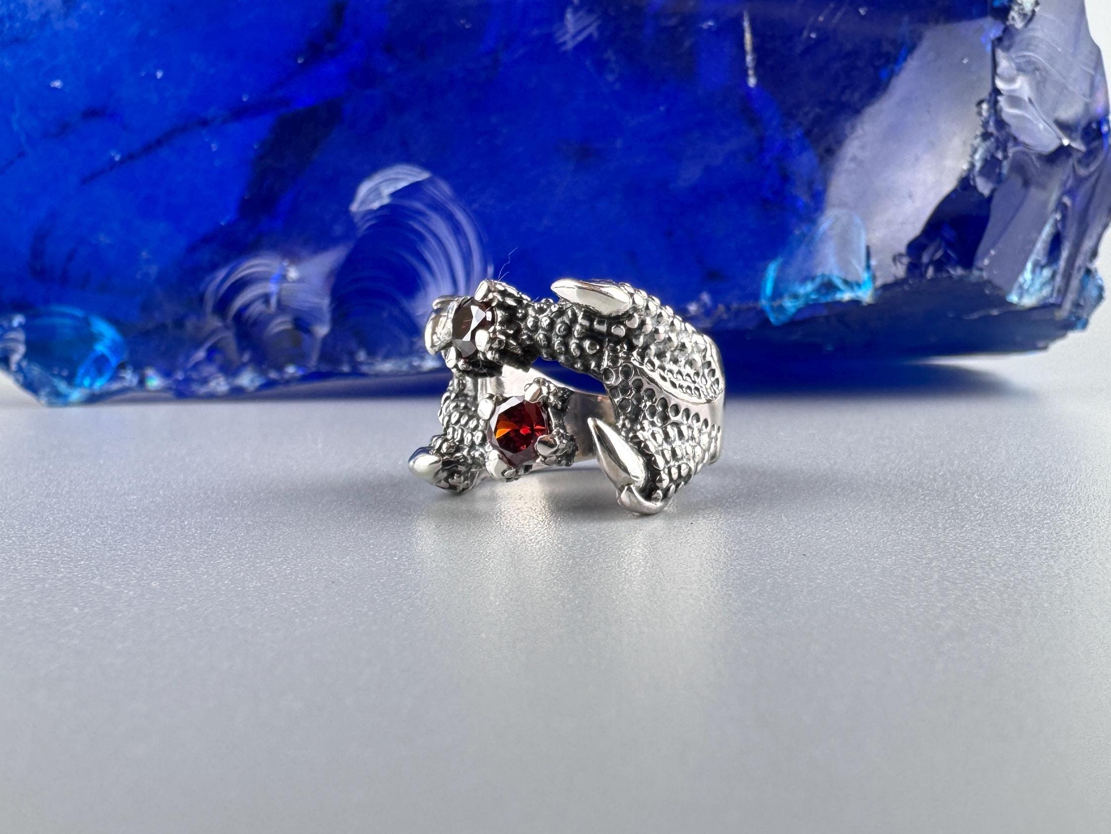 Side view of the Crimson Claw ring showing scaled dragon body and talons