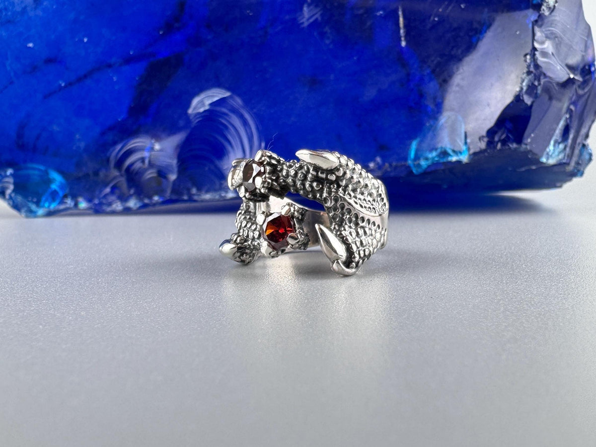 Side view of the Crimson Claw ring showing scaled dragon body and talons