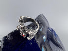 Close-up of the sculpted dragon claw and faceted red garnet