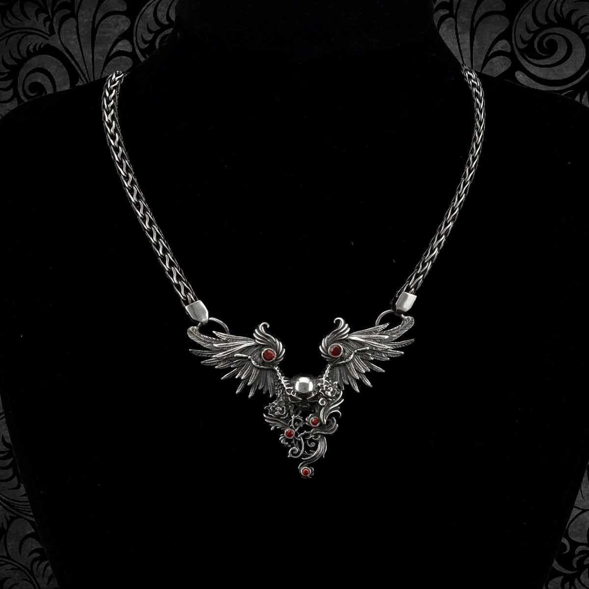 Dark Angel gothic skull and wings necklace on a black bust, full woven silver chain