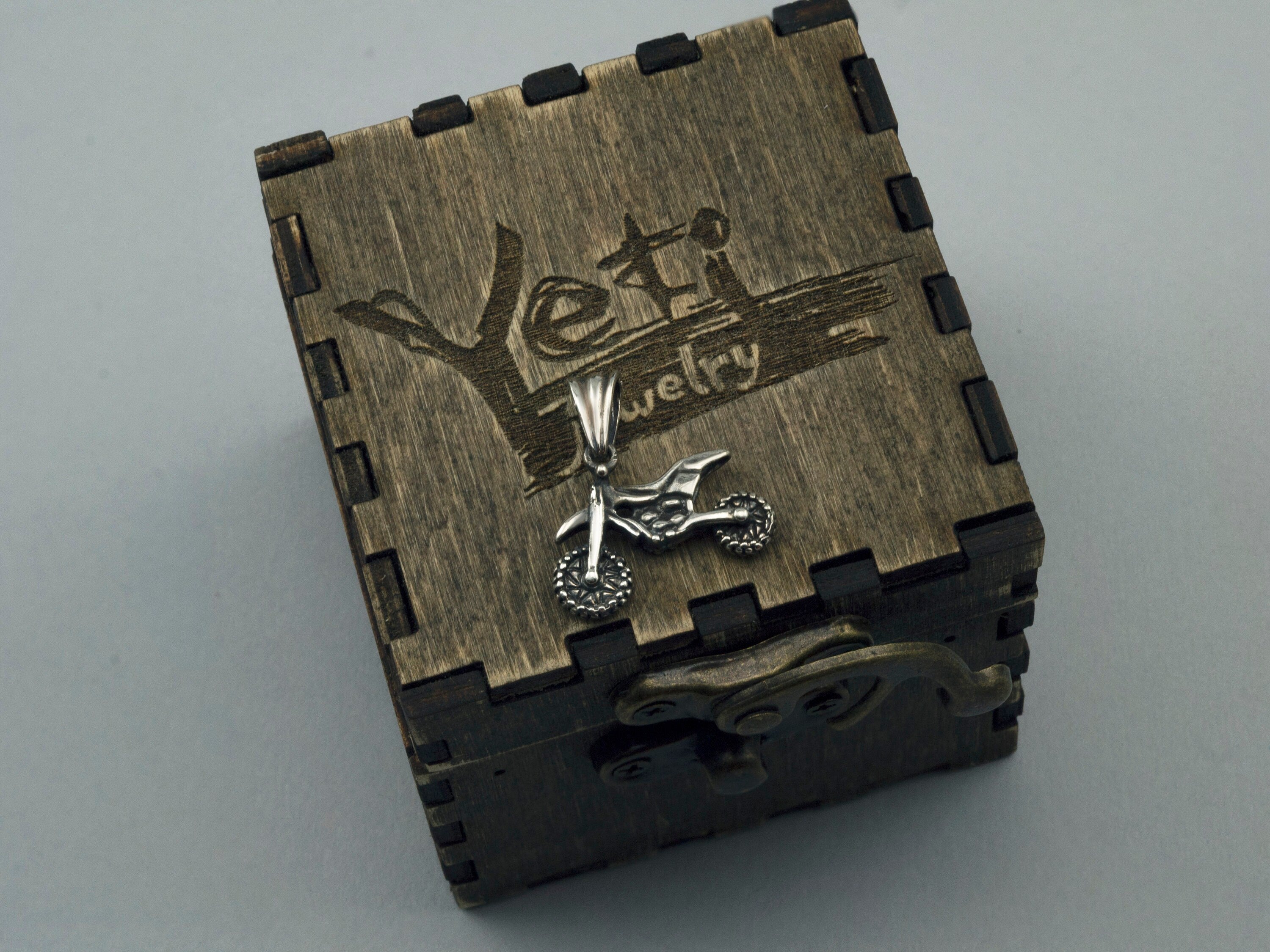 Enduro biker pendant displayed on an engraved wooden gift box
