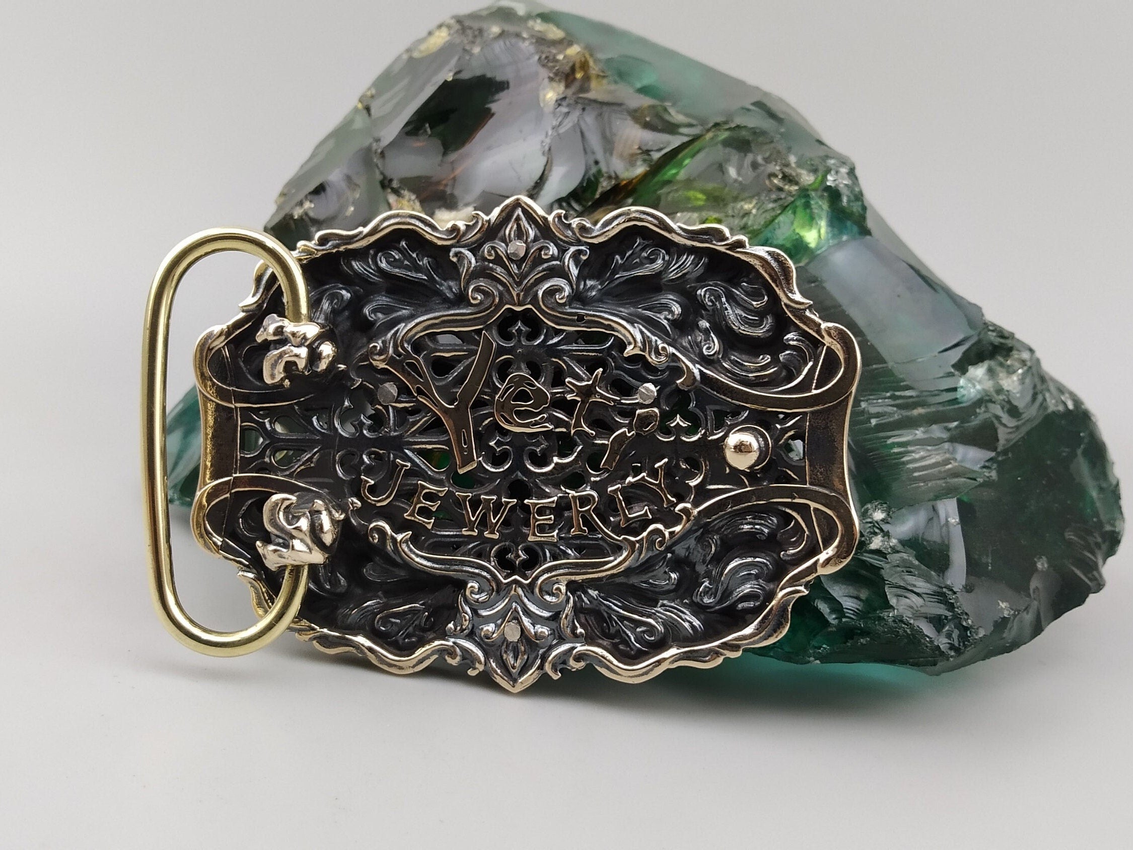 Silver and brass gothic belt buckle, side view showing 13 mm thickness