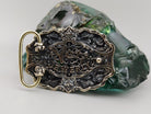 Silver and brass gothic belt buckle, side view showing 13 mm thickness