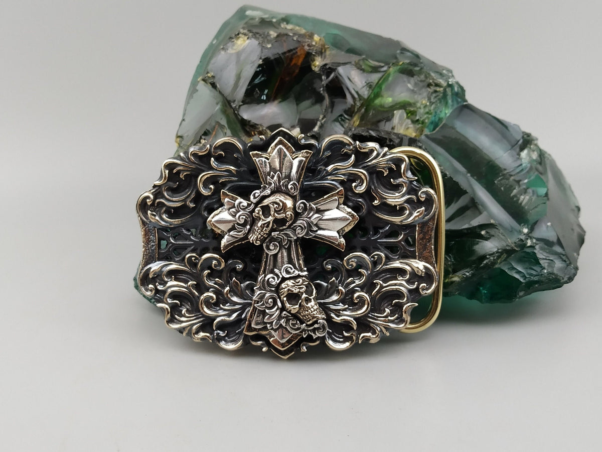 Eternal Conqueror cross and skulls belt buckle in sterling silver and brass