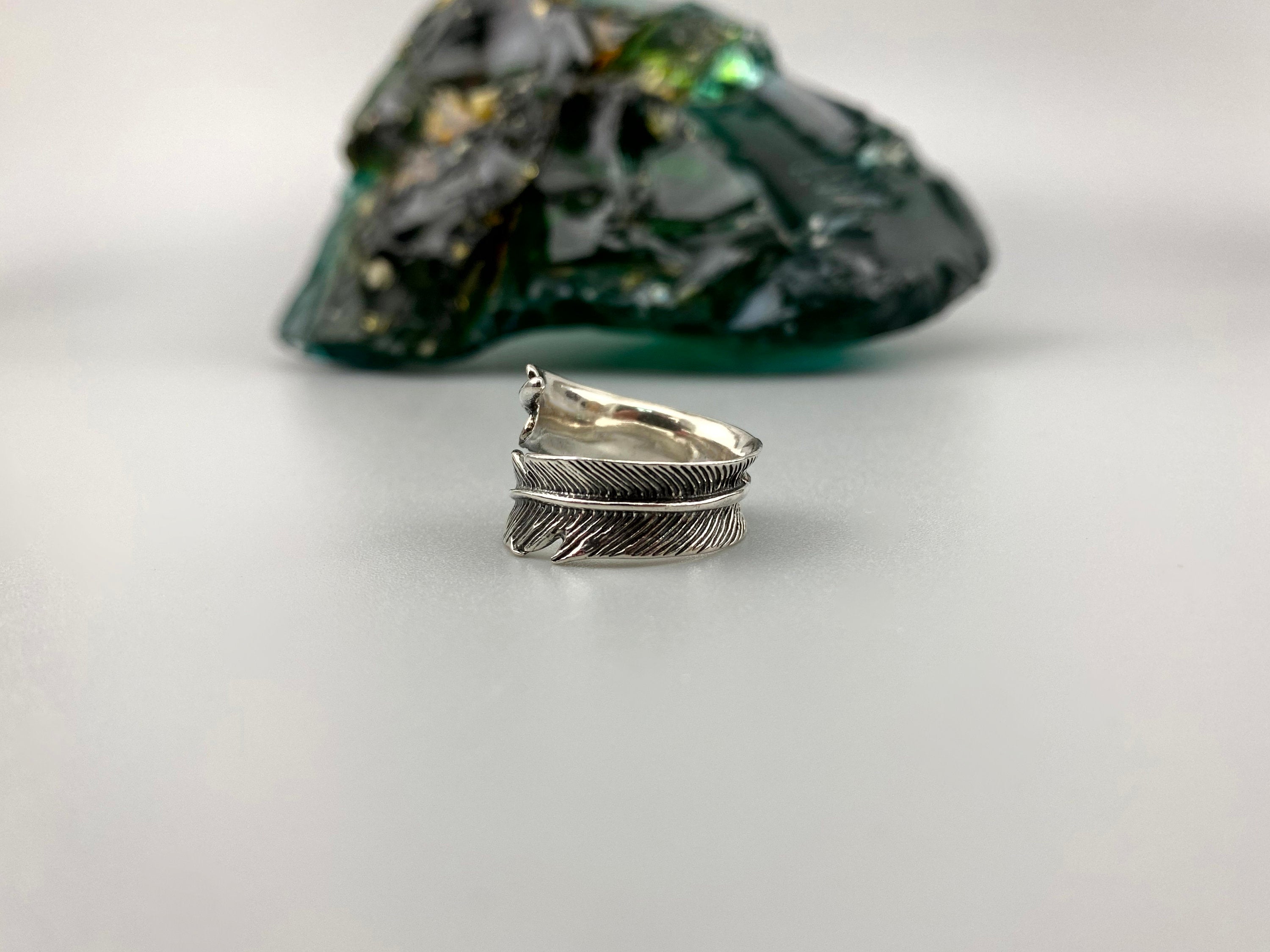 Boho sterling silver feather ring, top view of the bypass design