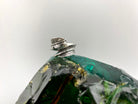 Silver feather ring standing on its band, side view of the two feathers