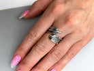 Feather sterling silver ring on a woman's hand with pink manicure