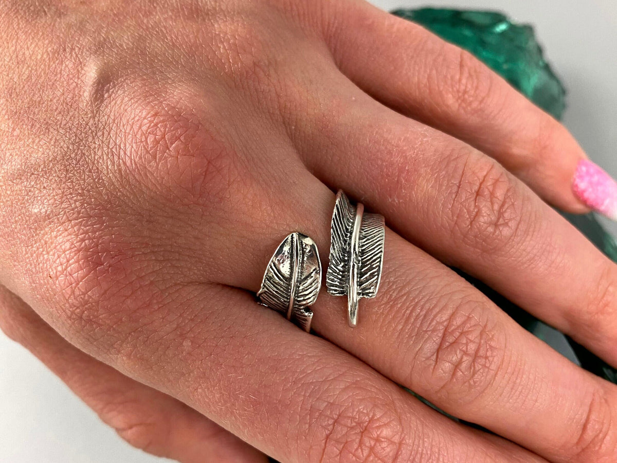 Women's feather wrap ring worn on the index finger, hand view