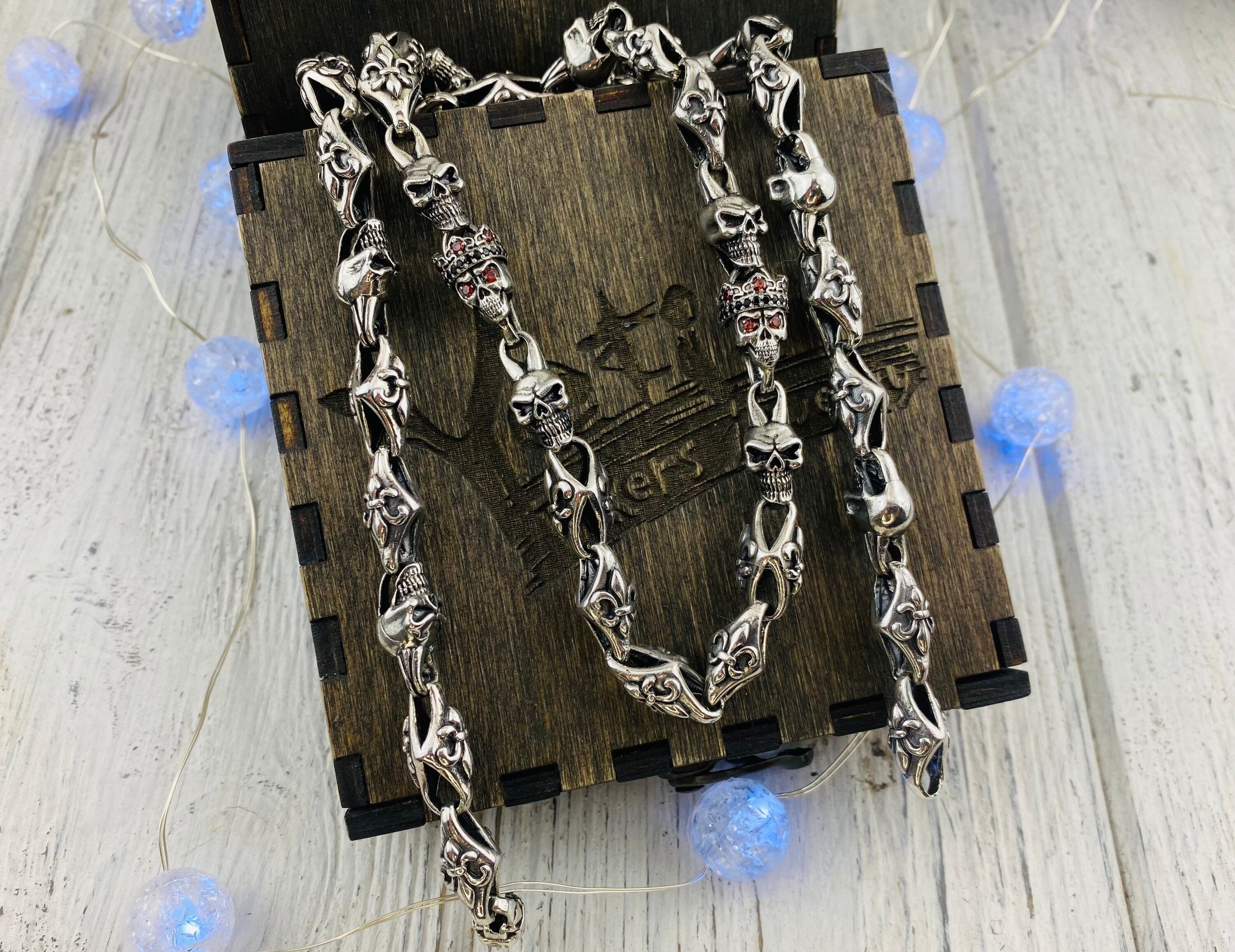 Fleur de lis skull chain hanging over a wooden gift box