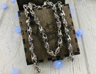 Fleur de lis skull chain hanging over a wooden gift box