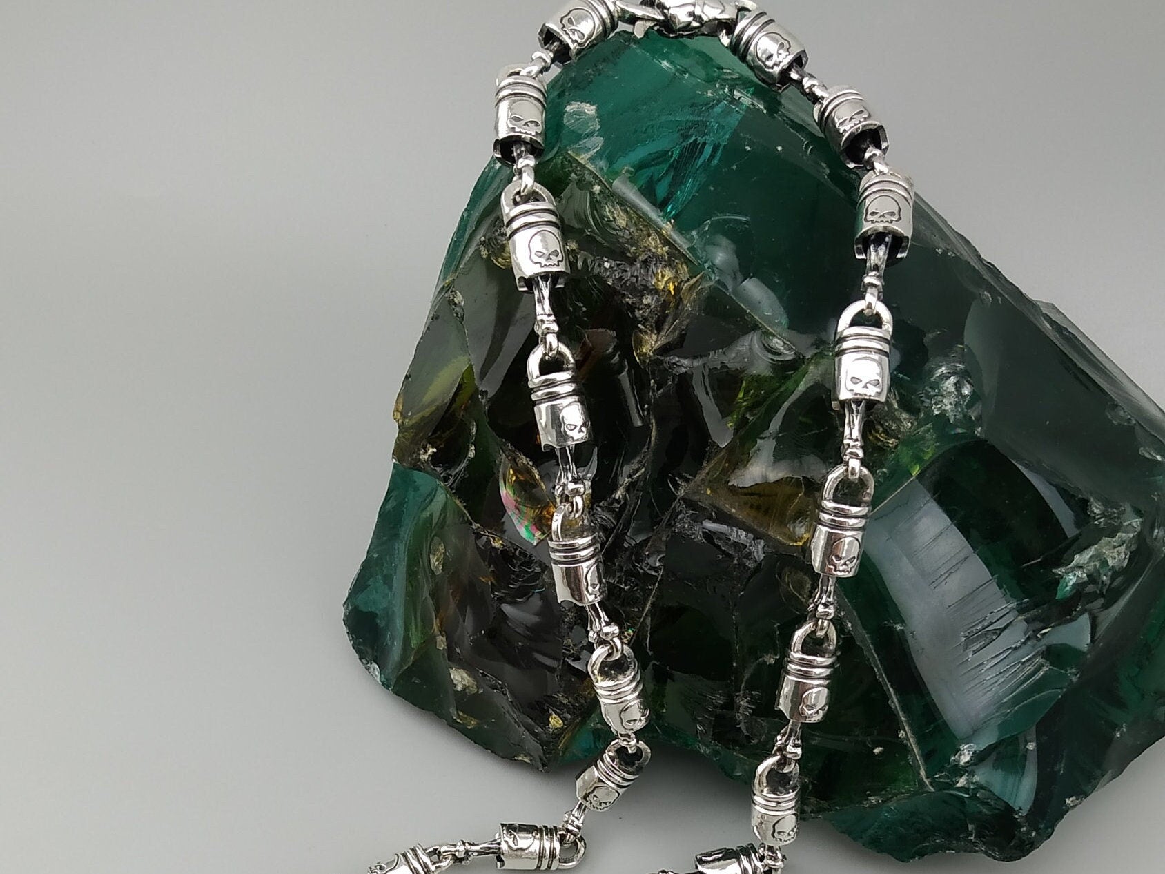 Forcer biker chain draped over a rock, showing the clasp end