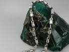Forcer biker chain draped over a rock, showing the clasp end