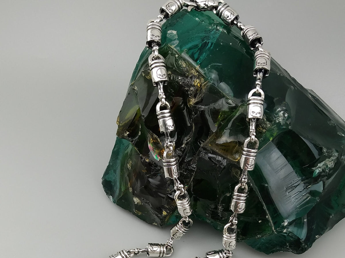 Forcer biker chain draped over a rock, showing the clasp end