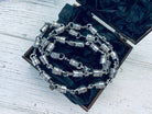 Forcer heavy silver chain inside an open wooden gift box