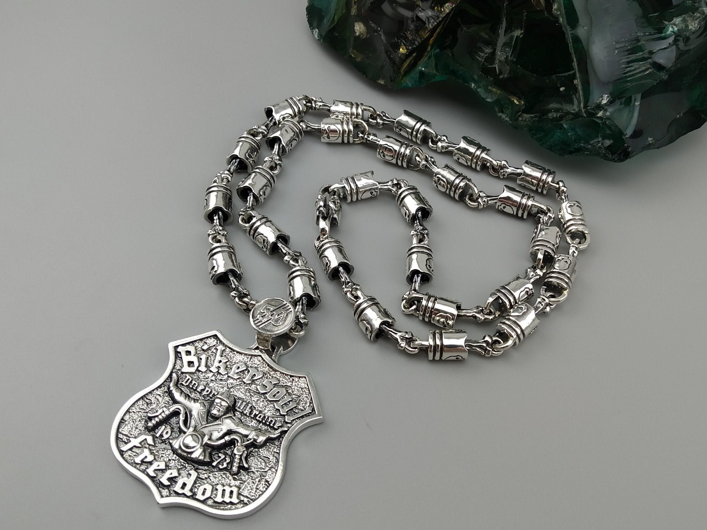 Forcer biker chain shown with a silver badge pendant