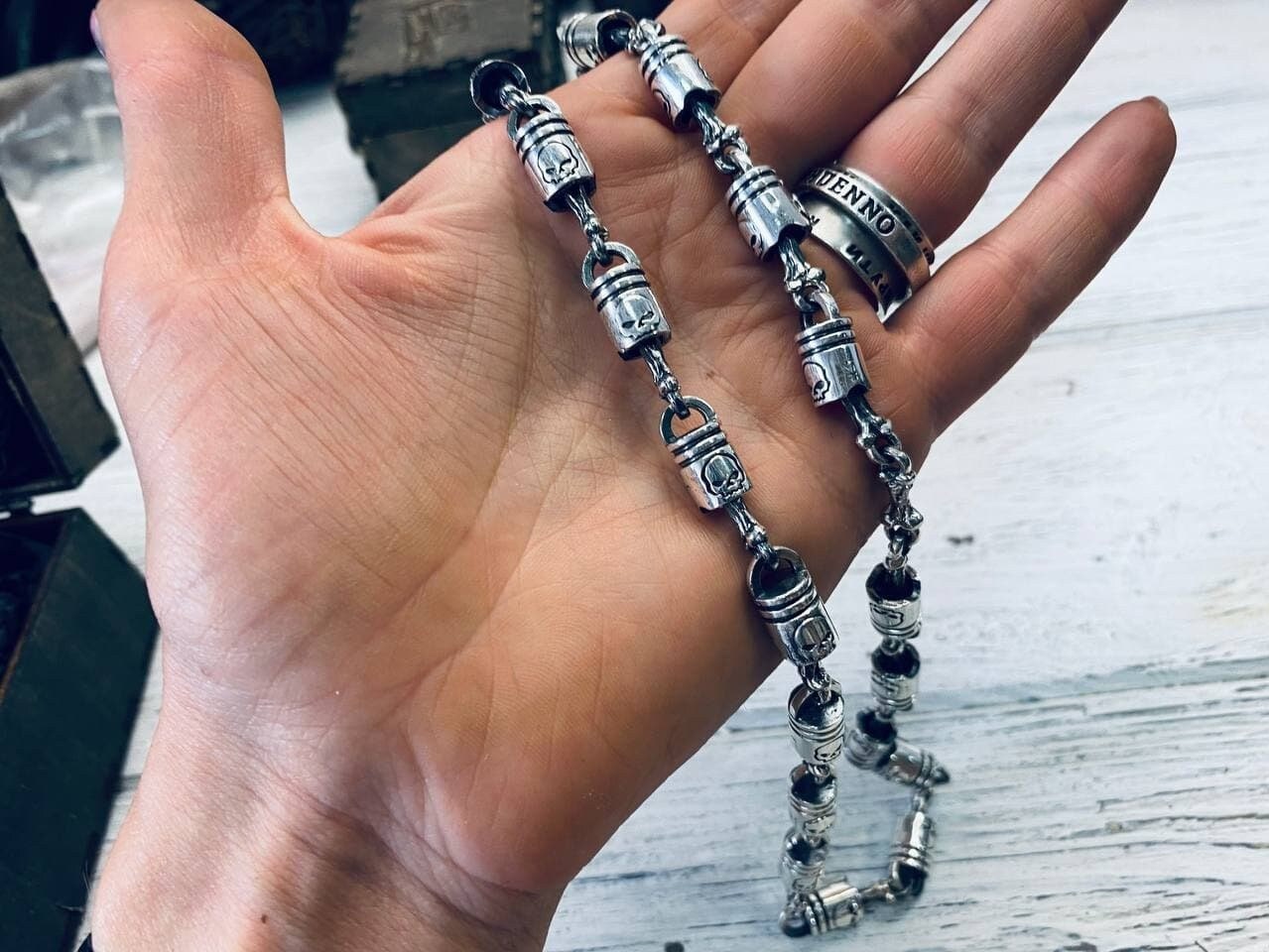 Heavy Forcer sterling silver chain held in an open palm