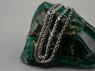 Forge heavy sterling silver chain hanging in long strands, showing link pattern