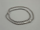 Forge sterling silver chain laid flat in an oval, showing the lobster clasp