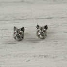 French bulldog sterling silver stud earrings on white wood, front view