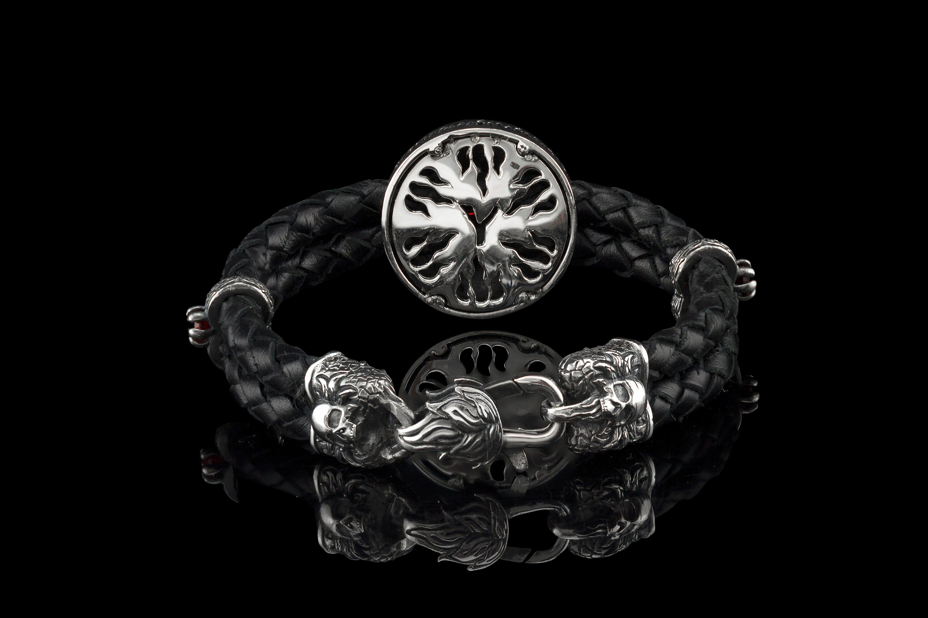 Back of the silver skull medallion and sculpted clasp on the black braided leather bracelet