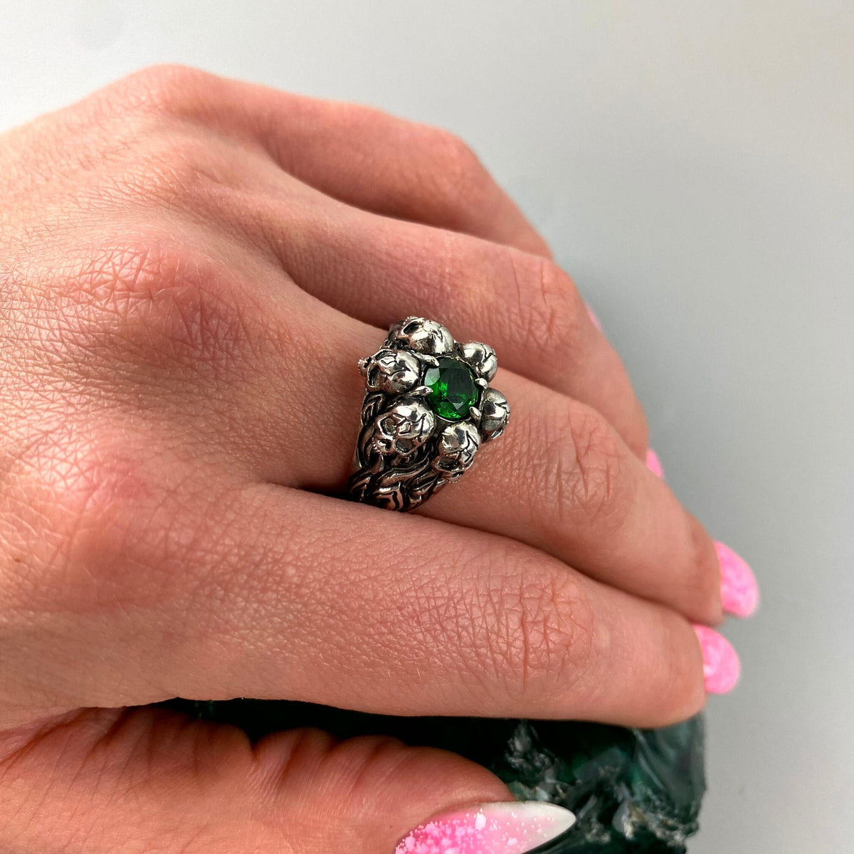 Furious Bonnie green skull ring worn on a woman's finger