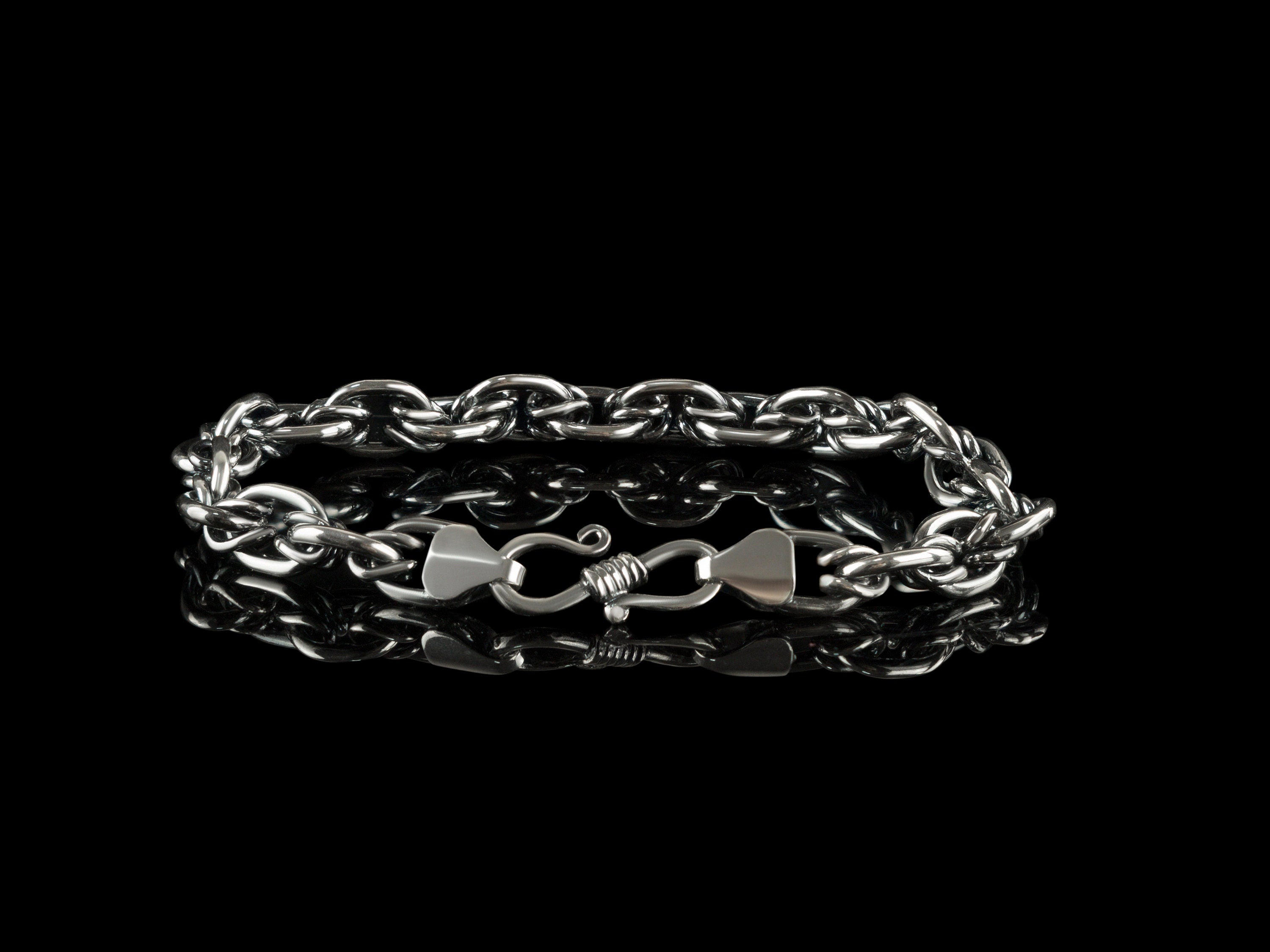 Graf chain bracelet with clasp in front, on black background