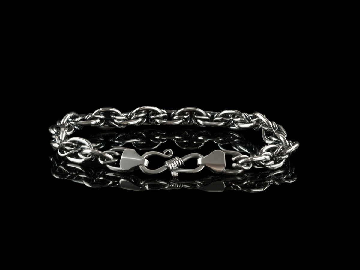 Graf chain bracelet with clasp in front, on black background