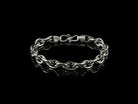 Graf men's silver chain bracelet laid in a circle on black