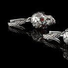 Skull drop earrings with leverback locks laid out on black